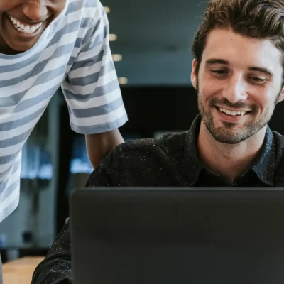 colleagues-discussing-their-work-laptop